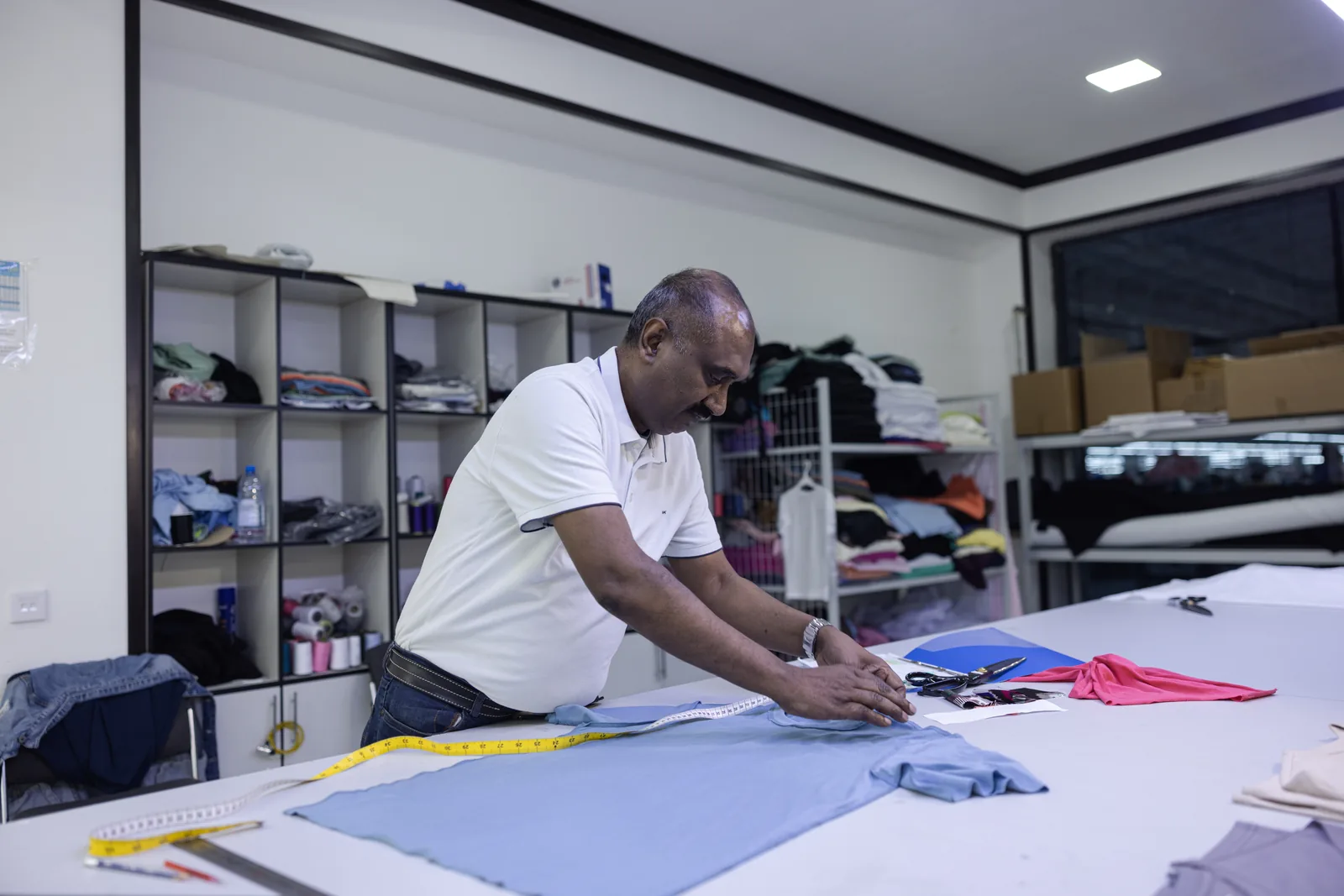 Quality control team inspecting knitwear garments at Amirtex